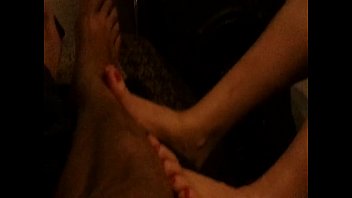sexy milf with rubs feet on dude for money